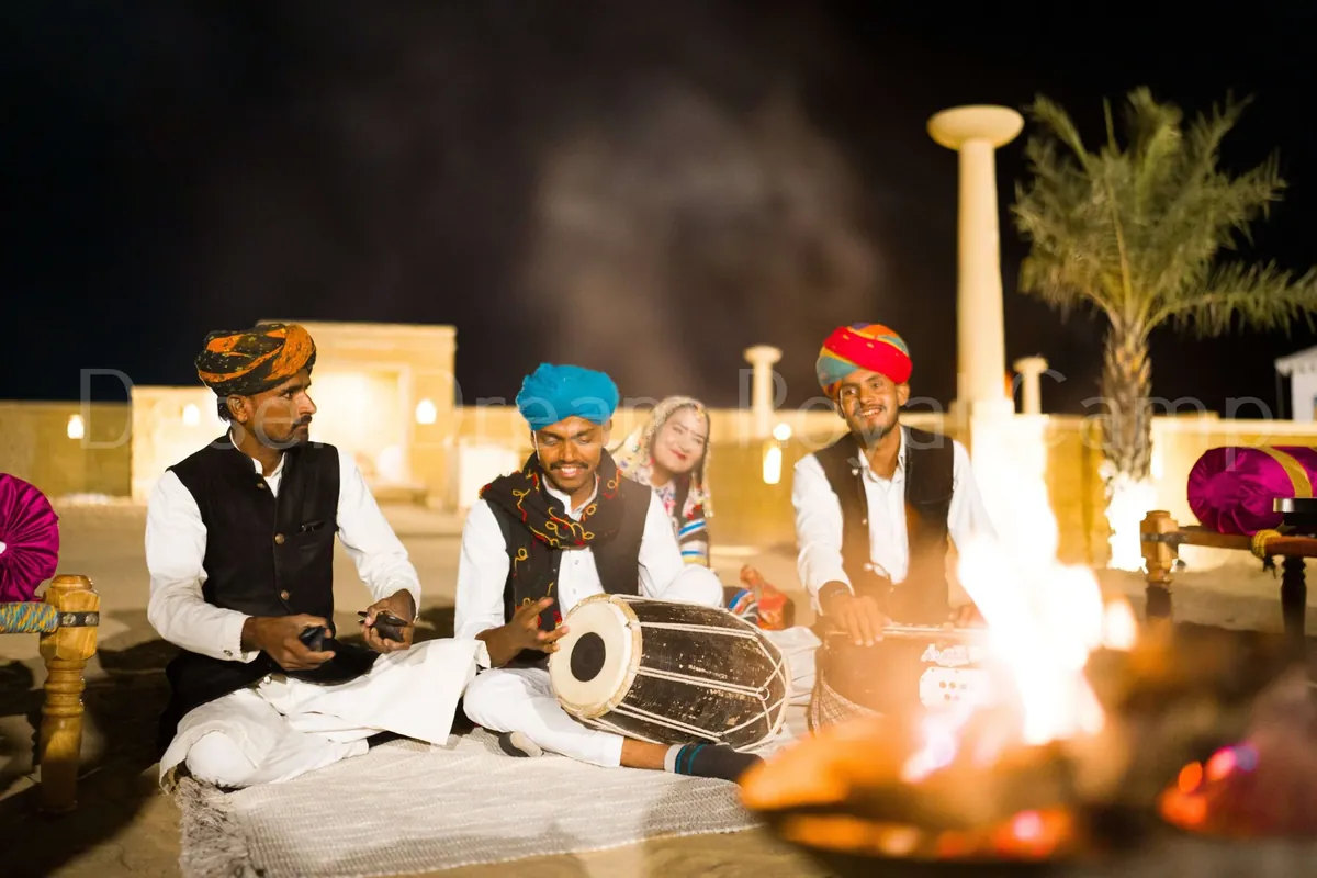 Folk musicians playing by the fire at the camp