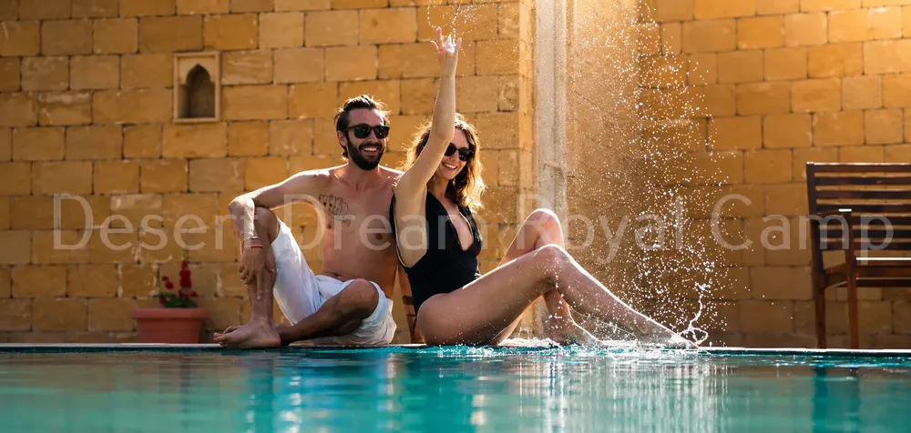 Guests relaxing in the camp pool