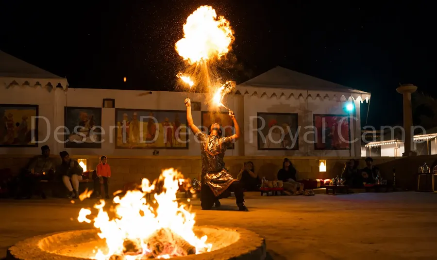 Fire dancer performing at the camp at night
